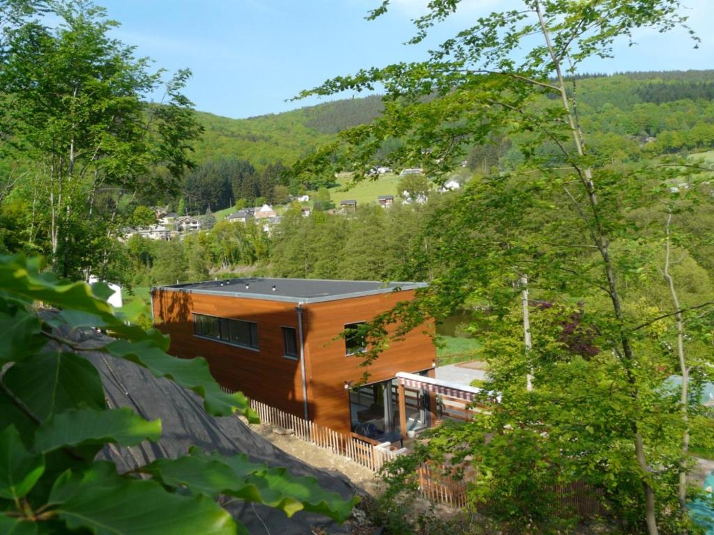 a house in the middle of a forest at Well Coom in Goé