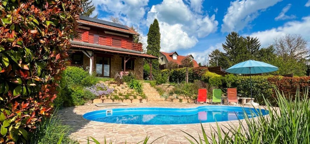 a house with a swimming pool in the yard at Villa Limhamn - Őrbottyán in Őrbottyán