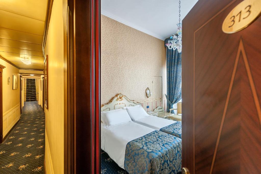 Postel nebo postele na pokoji v ubytování Hotel Montecarlo