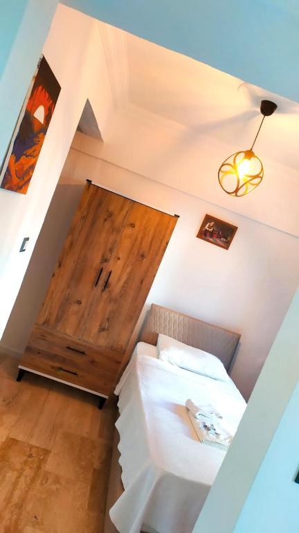 a room with a bed and a wooden door at Haluk Otel in Oren