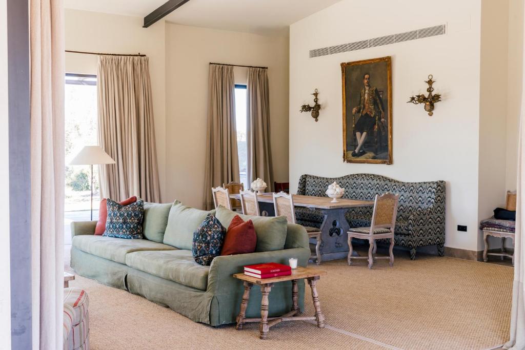 a living room with a couch and a table at Casa Torrenueva - Luxury Country House in Lebrija
