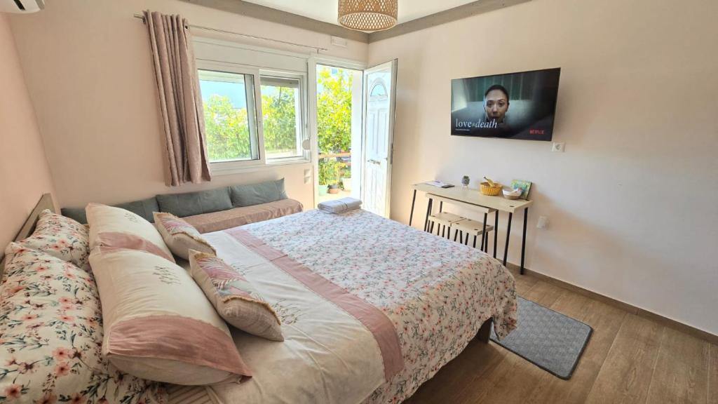 a bedroom with a large bed and a window at Semelia & Maria's Guest Houses - Cozy Stay for 2 in Spata