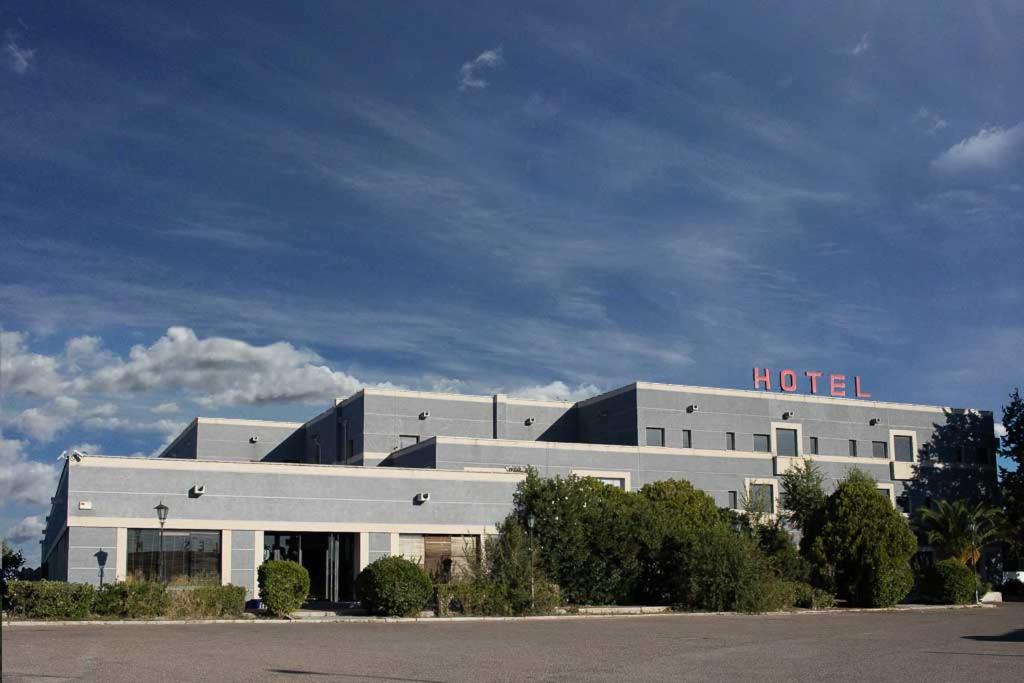 a large white building with a motel sign on it at Hotel Recio in Santa Olalla de Toledo