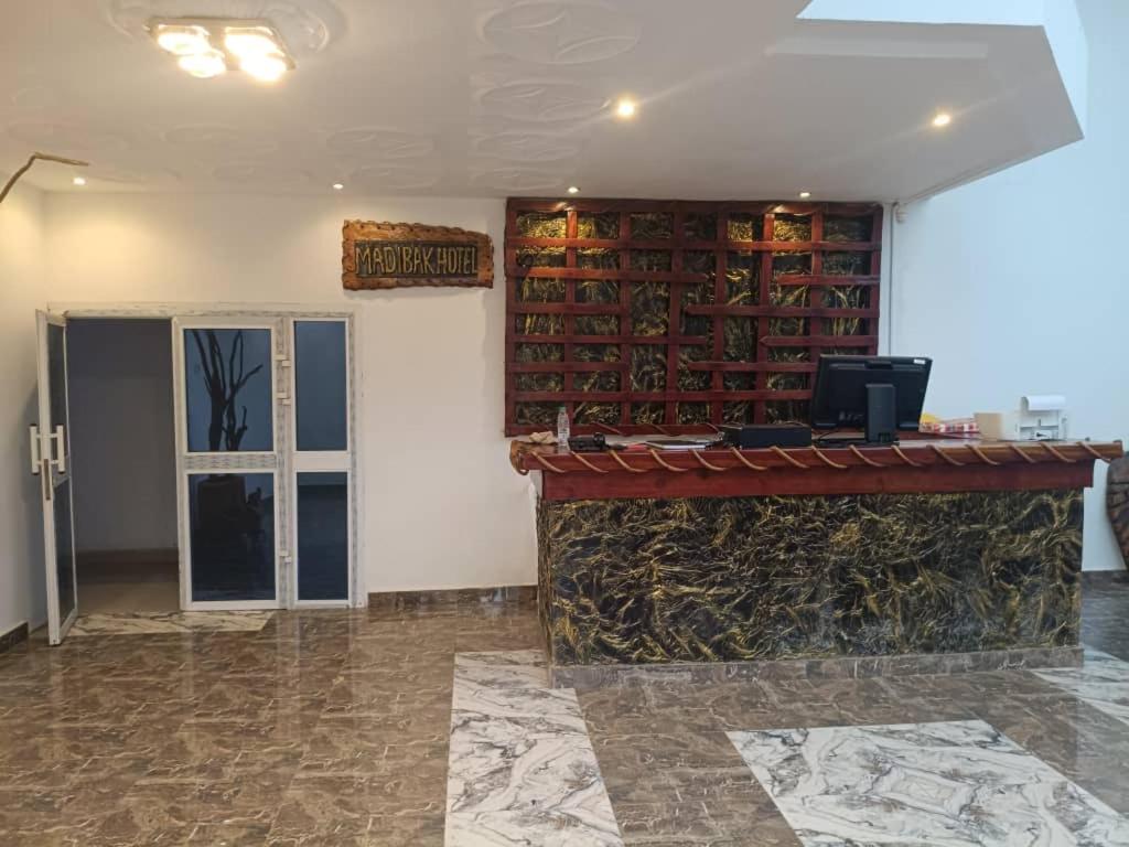 a room with a fireplace with a tv on top at Madibak Hotel Limbe in Limbe