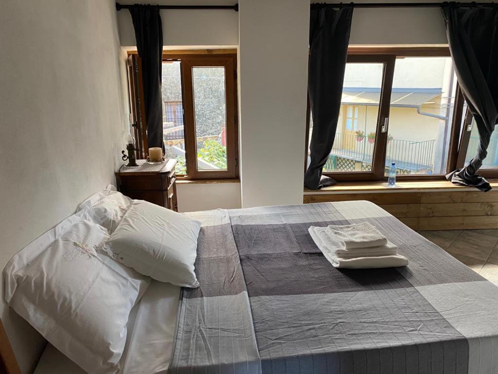 a bedroom with a bed with two towels on it at Locanda Tarello 1880 in Roppolo