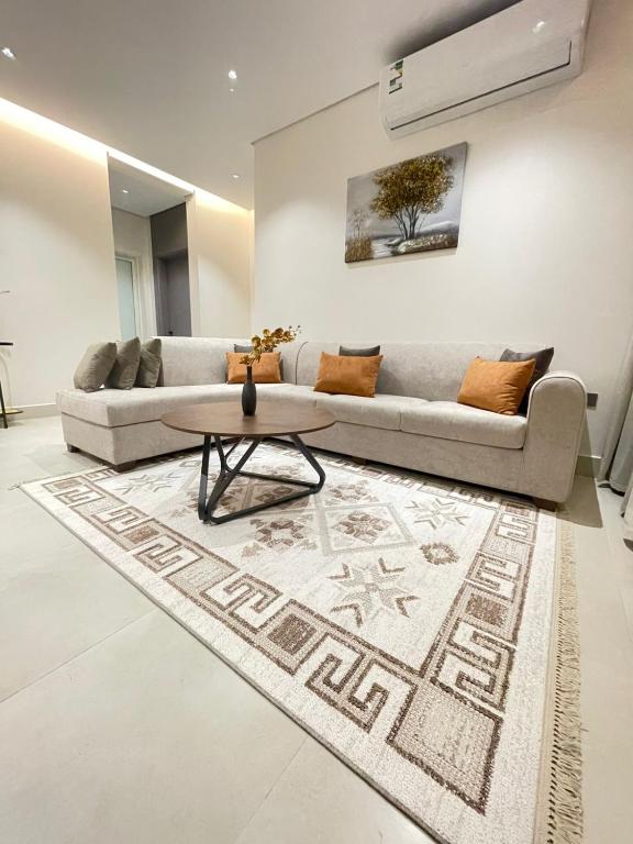 a living room with a couch and a table at شقة مفروشة in Al Khobar