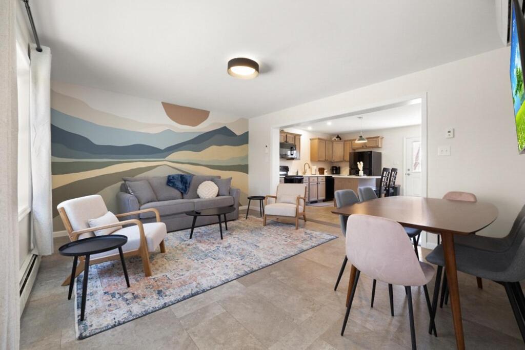 a living room with a couch and a table at Maine Woods Retreat in Ellsworth