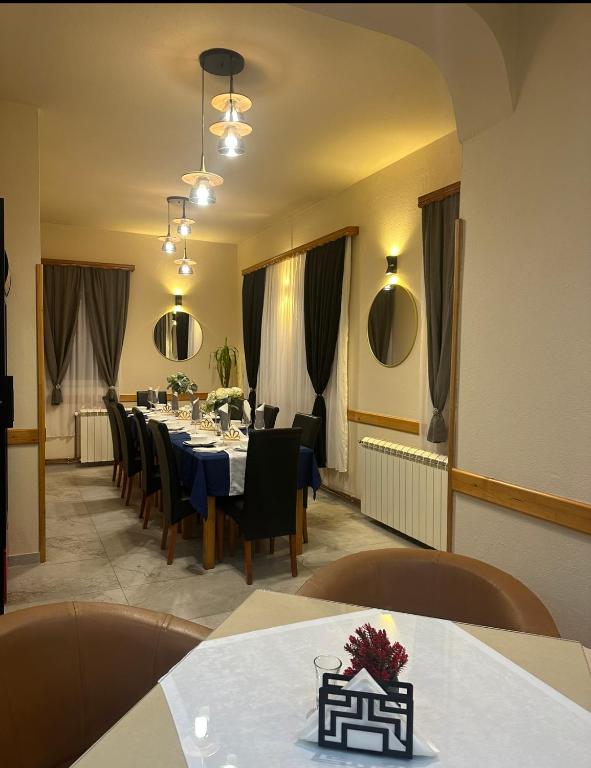 a dining room with a long table and chairs at Motel Grand in Rožaje