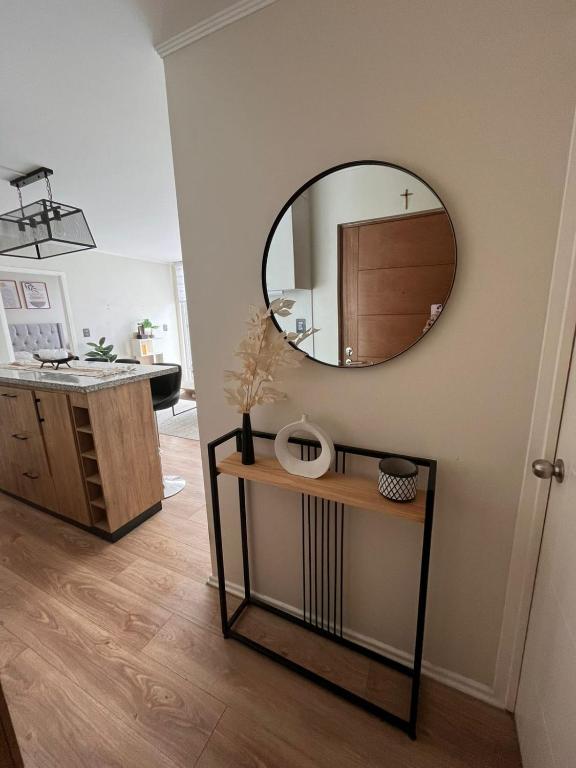 a bathroom with a mirror on the wall and a sink at Lindo Brisas in Talcahuano
