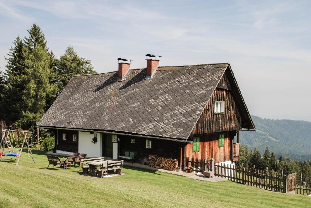 a large wooden house with a gambrel roof at Biobauernhof Gegg in Schwanberg