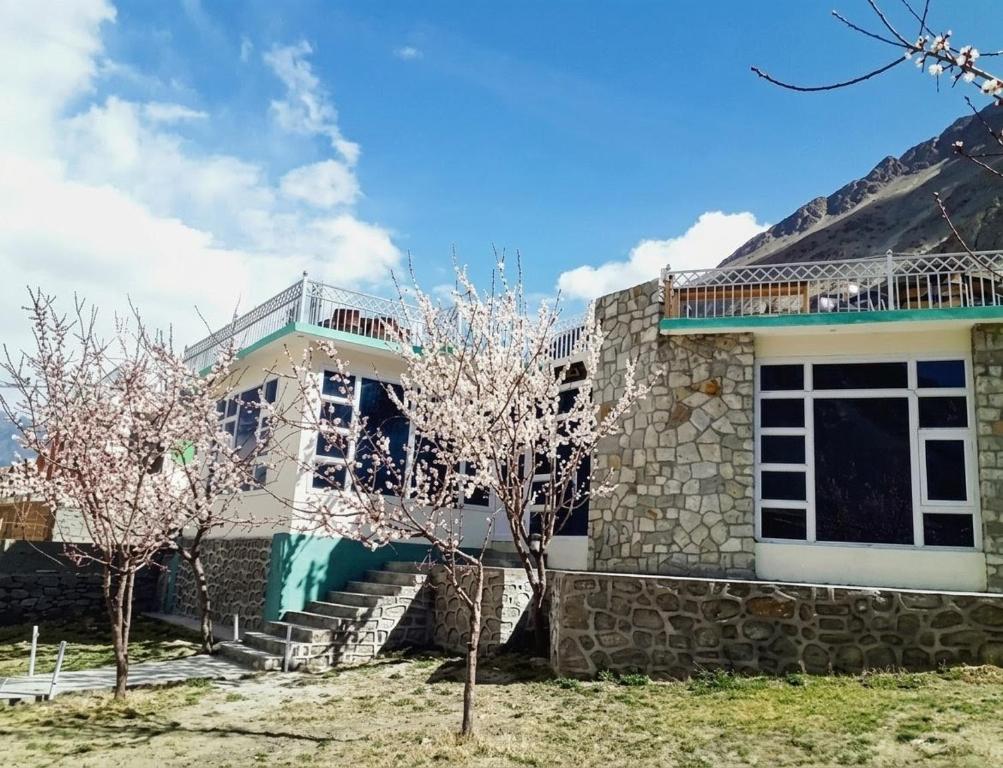 a house with trees in front of it at Ameer lodge in Hunza Valley