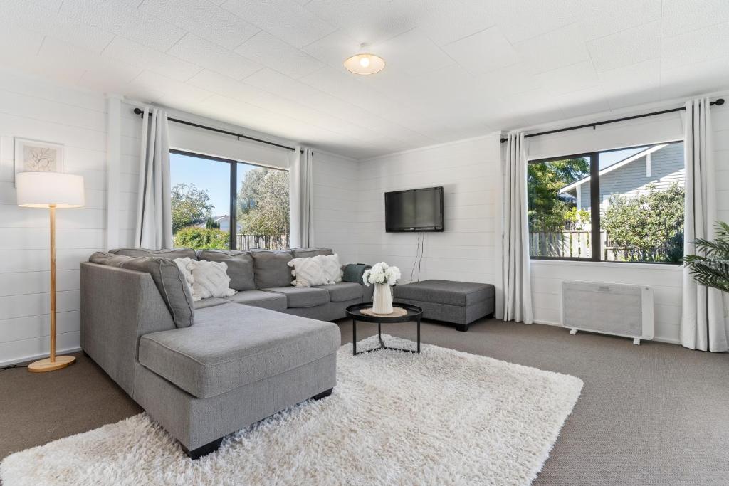 a living room with a couch and a tv at Lockwood on Cologne in Martinborough