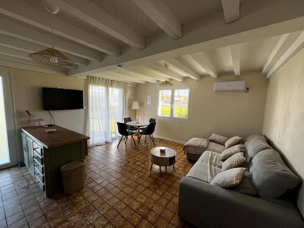 a living room with a couch and a table at T2 charmant dans les Landes in Lesperon