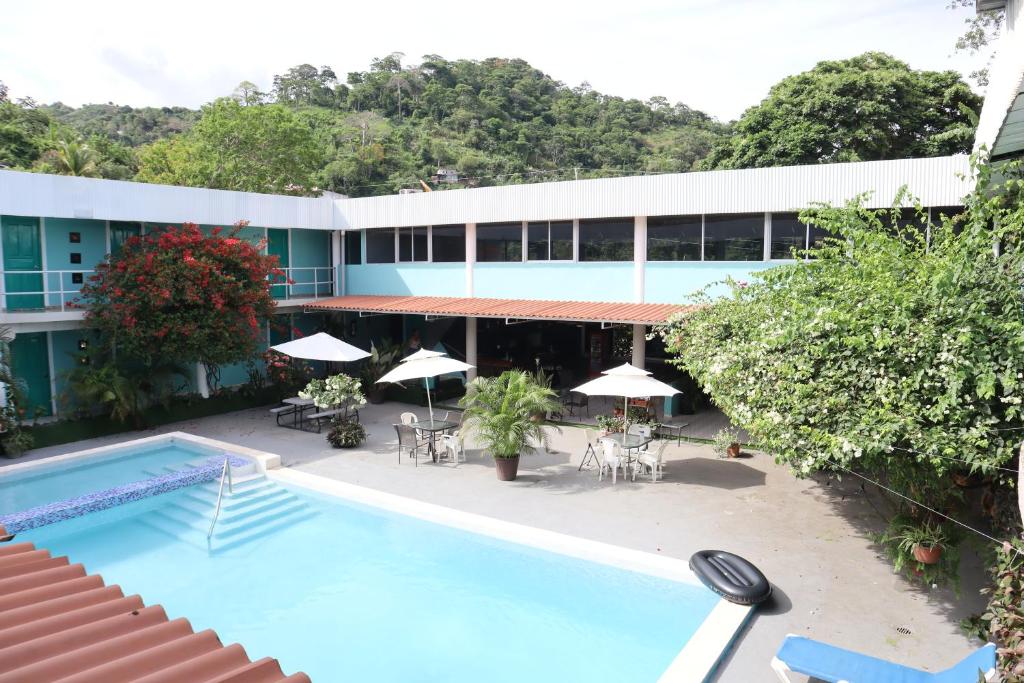 an aerial view of a hotel with a swimming pool at Pacific Coast Hotel in Playa Bonita Village