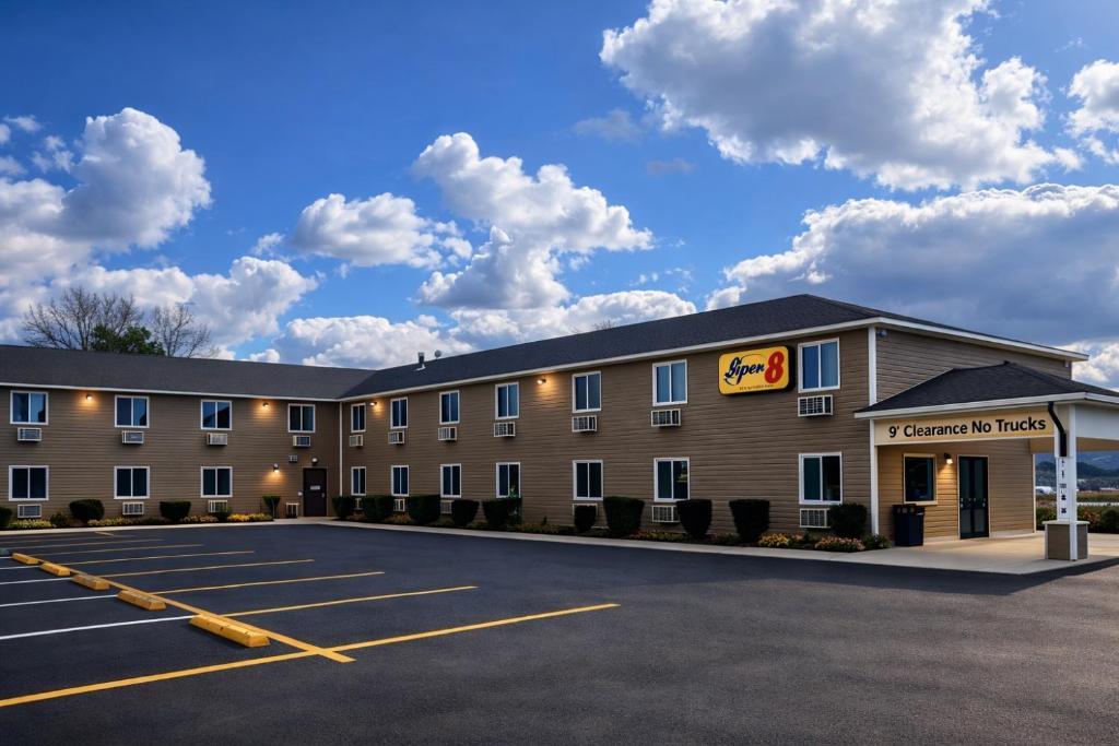 a front view of a hotel with a parking lot at Super 8 by Wyndham Lewiston in Lewiston