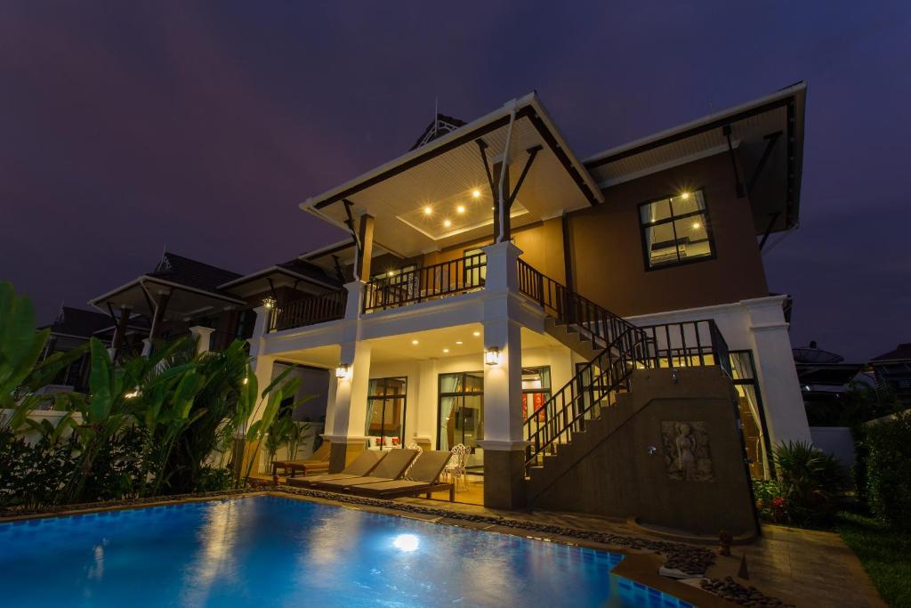 a villa with a swimming pool at night at The Best Ao Nang Villas in Ao Nang Beach