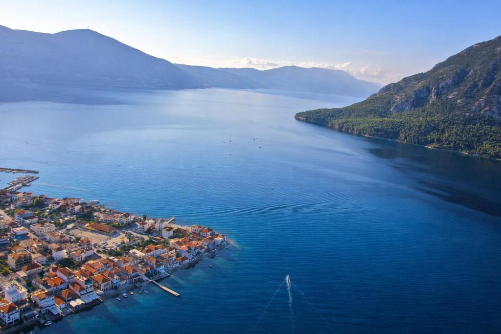 an aerial view of a town in the middle of a lake at Hotel Simos in Mitika