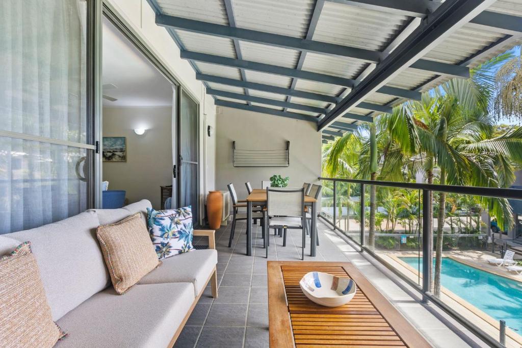 a living room with a couch and a table at Baden 74 Rainbow Shores in Rainbow Beach