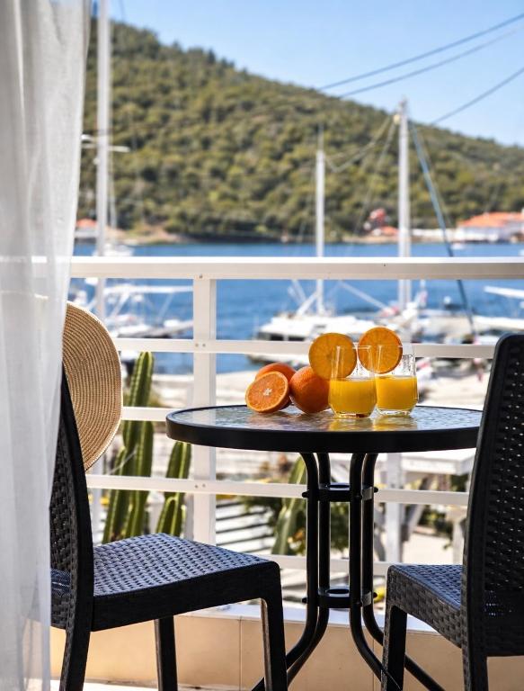 a table with oranges on top of a balcony at Puerto Porto Koufo in Porto Koufo