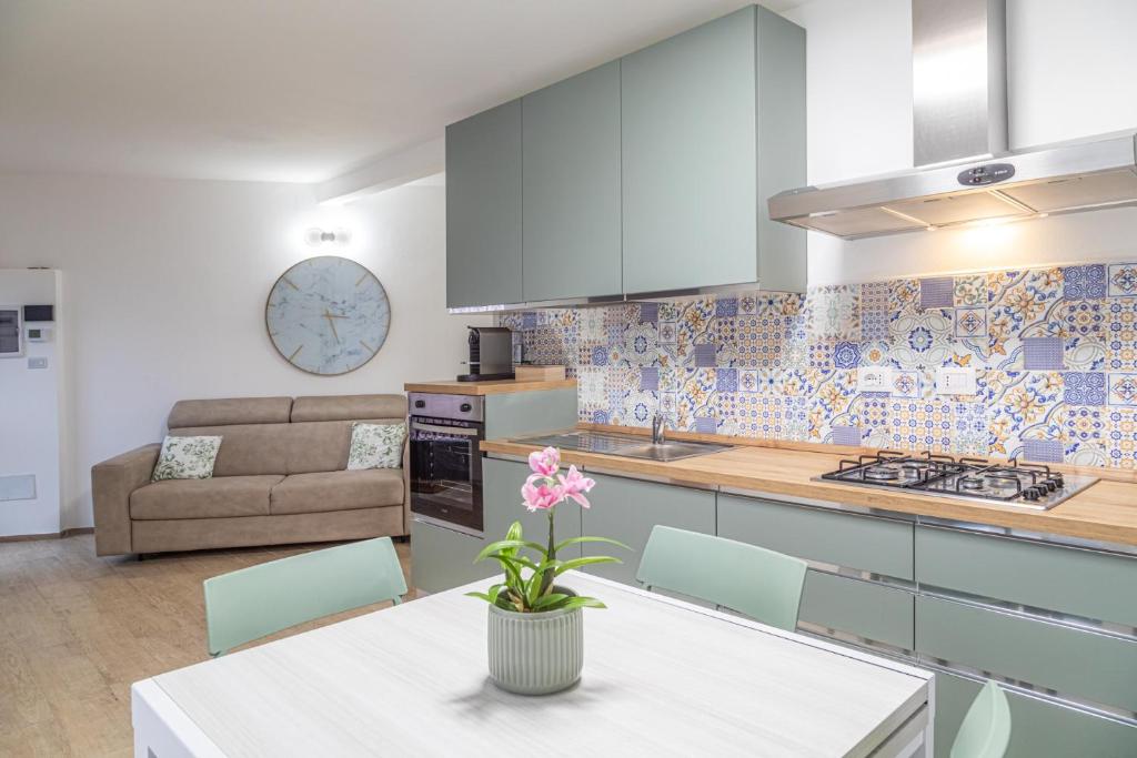 a kitchen and living room with a table and a couch at Sara Home Flo in Florence