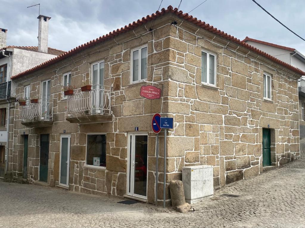 a stone building with a sign on the side of it at Casa da Praça de Murça in Murça