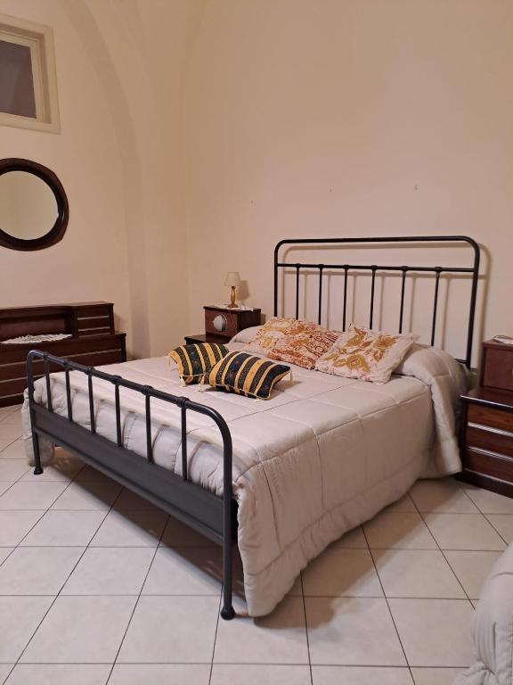 a bedroom with a large bed with pillows on it at Casa in centro a Giarre in Giarre