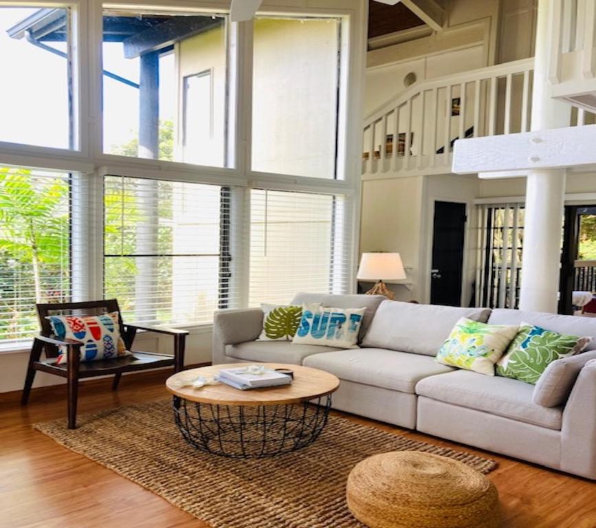 a living room with a couch and a table at Princeville North Shore Retreat - 1200 SF, Lanai, Loft & Kitchen in Princeville
