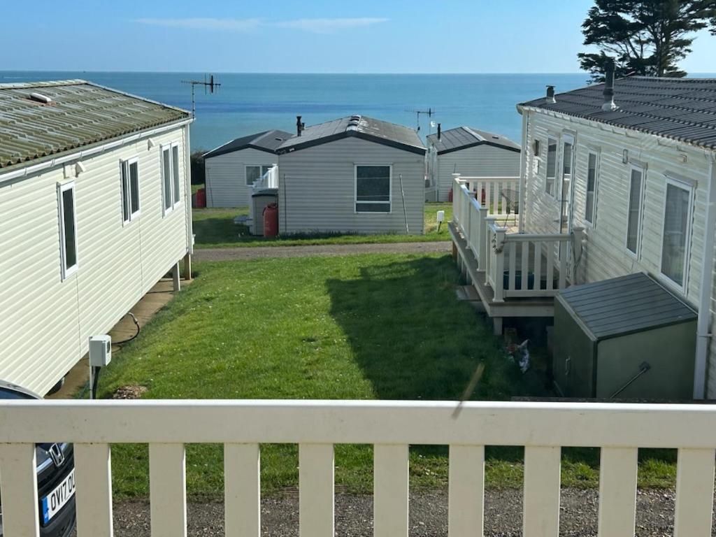 a view from a balcony of houses and the ocean at Sandhills Holiday Park Astounding Sea Views in Bembridge