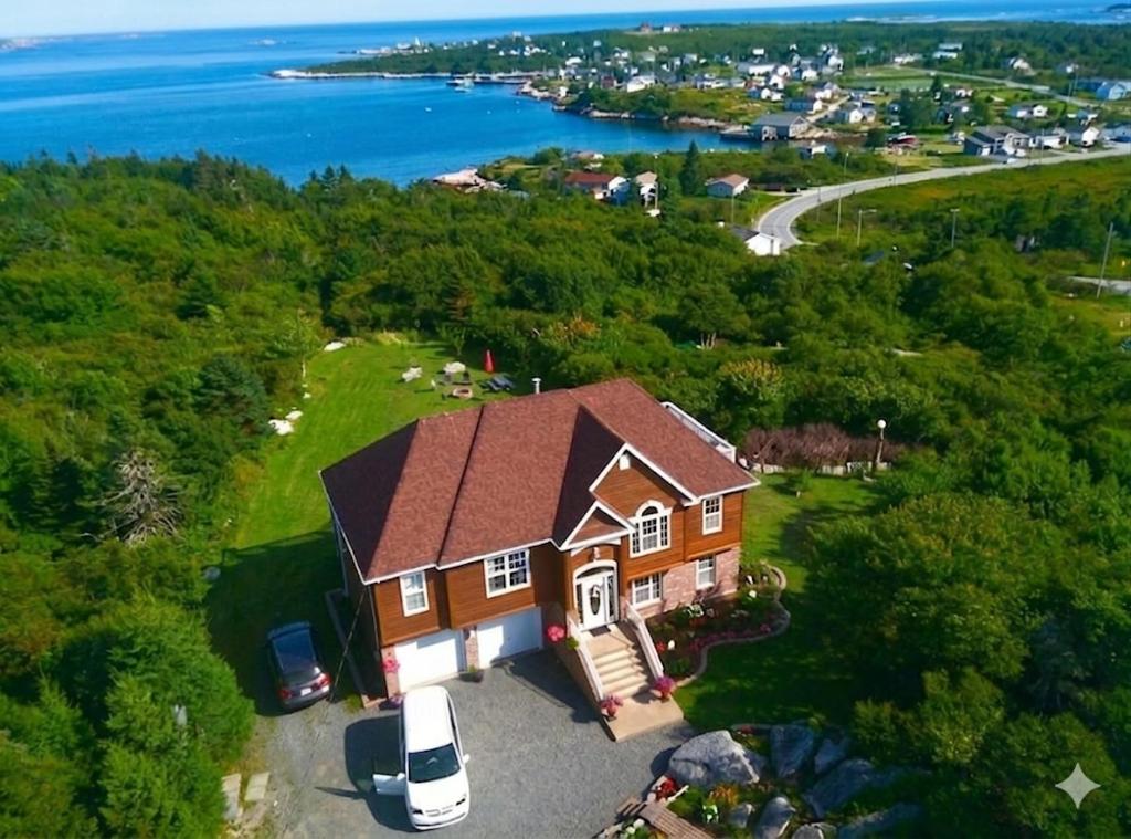 an aerial view of a house with a car parked in front at Panoramic Sunrise House in Terence Bay