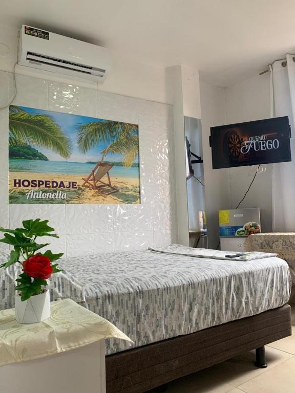 a hotel room with a bed and avertisement at Hospedaje Antonela in Manta