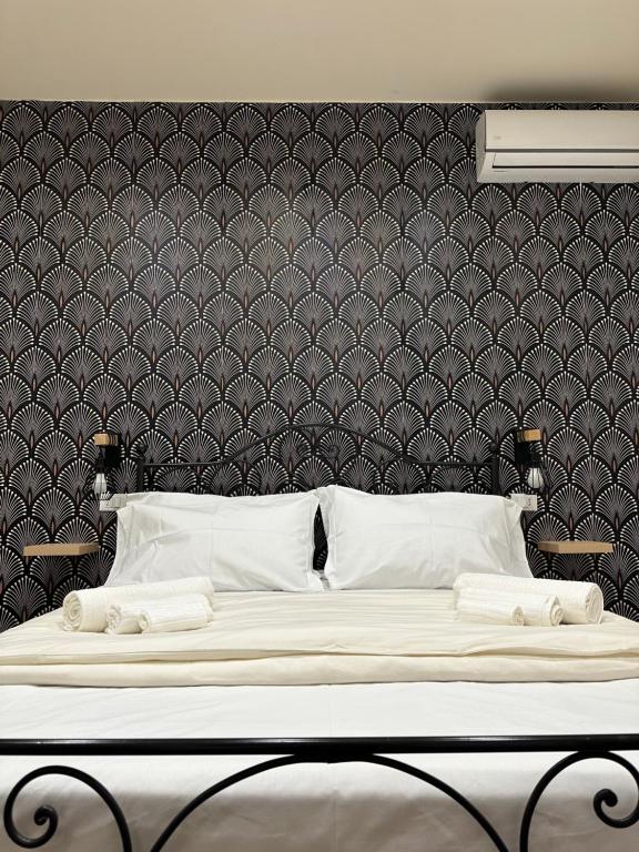 a bedroom with a large bed with a black wall at Almía apartment in Cinisi