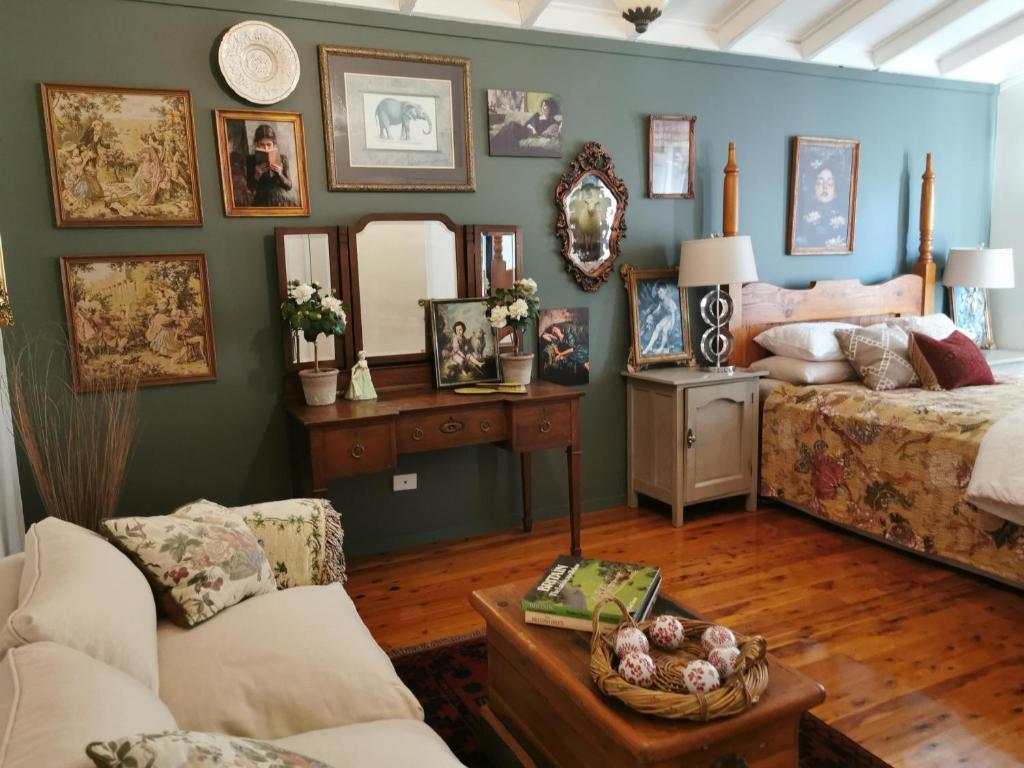 a room with a bed and a table with a couch at Wyndover Mountain Retreat in Beechmont