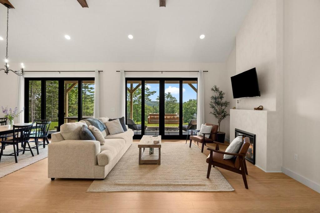 a living room with a couch and a fireplace at Villa Acadia with Mountain Views in Bar Harbor