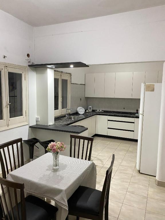 a kitchen with a table with a vase of flowers on it at Marías in Resistencia