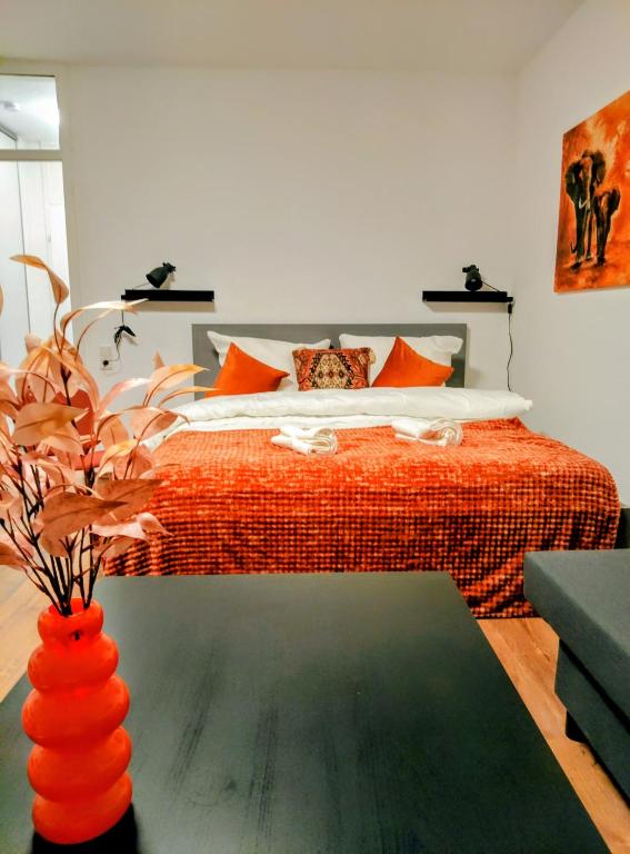 a bedroom with a bed and a vase with a plant at Chillout Zone Neuss - Apartment mit Balkon in Neuss