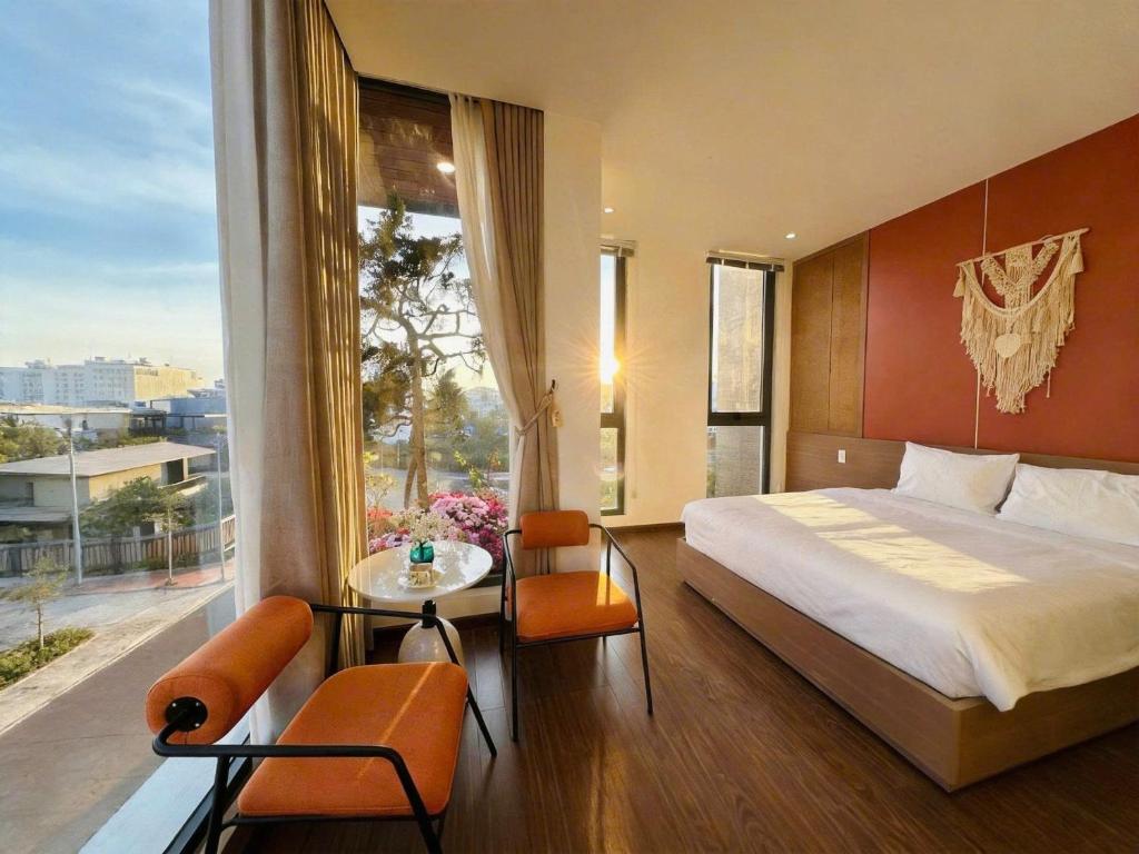 a bedroom with a large bed and a large window at Arora Home Pleiku in Pleiku