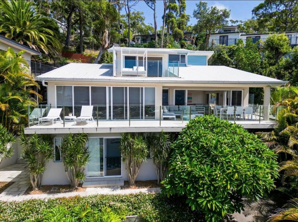 a house on the beach with palm trees at Acqua Vista in Terrigal