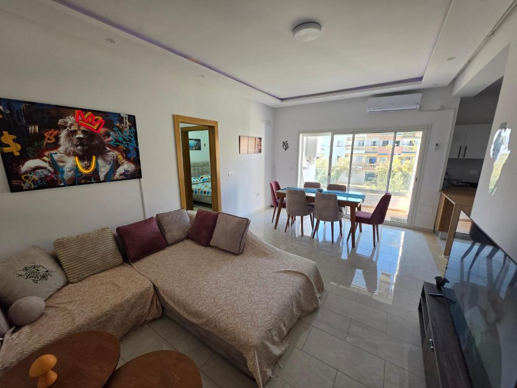 a living room with a couch and a table at Primavera Marmara Hamam sousse in Hammam Sousse
