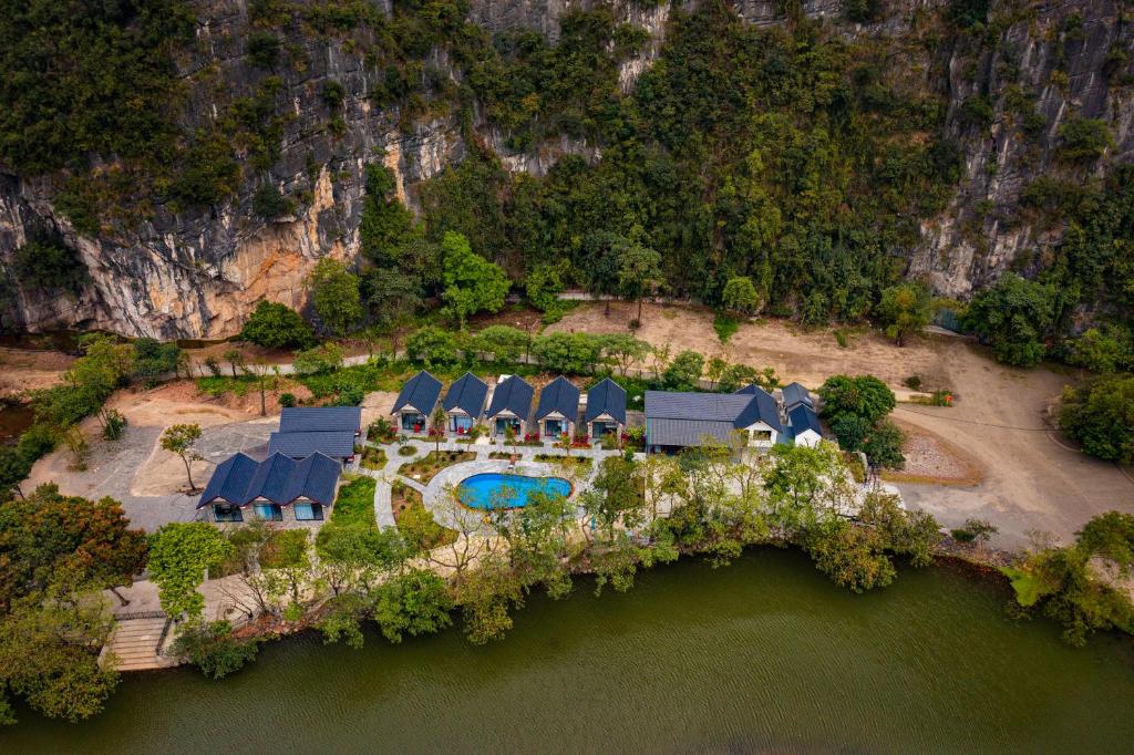 an aerial view of a house on an island in the water at Trang An River View Ecolodge in Ninh Binh