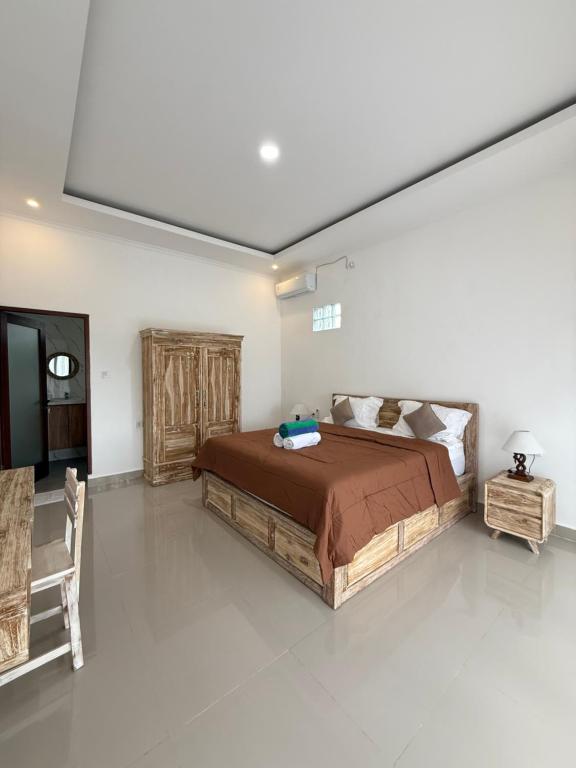 a bedroom with a large bed in a room at Puri Lepang Riverside in Ketewel