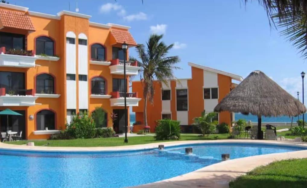 a resort with a swimming pool in front of a building at Tropical Oasis with Pool Perfect Vacation Home in Puerto Morelos