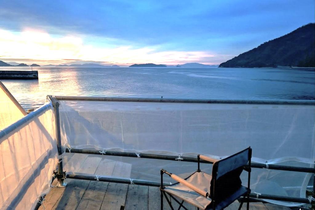 a chair sitting on the deck of a boat at Tiny House ZEN 倉橋島 in Kure