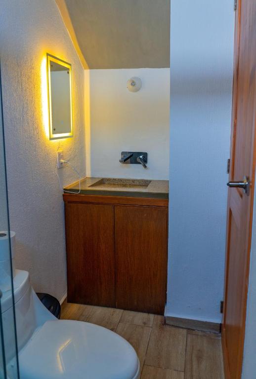 a bathroom with a sink and a toilet at Montepinar Acosta Suites in Mazamitla