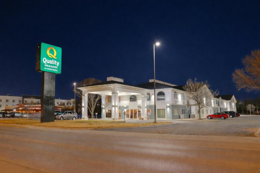 a gas station with a sign in front of it at Quality Inn & Suites Roswell North in Roswell