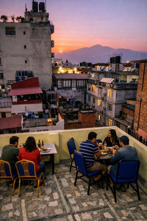 a group of people sitting at tables on a roof at Funky Monkey Hostel Hotel & Apartment Thamel in Kathmandu
