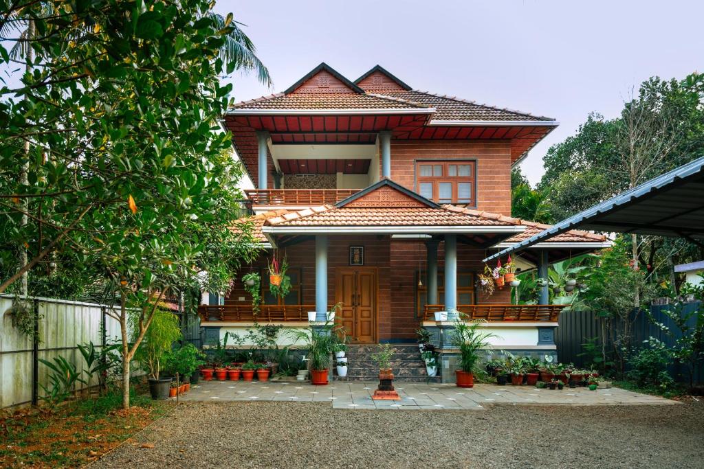 a house with a fence in front of it at Niramaya Heritage Homestay in Kottayam