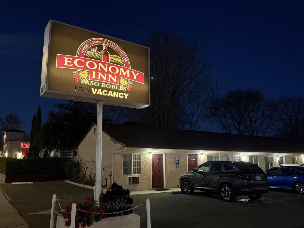 a sign for a restaurant in a parking lot at Economy Inn Paso Robles in Paso Robles