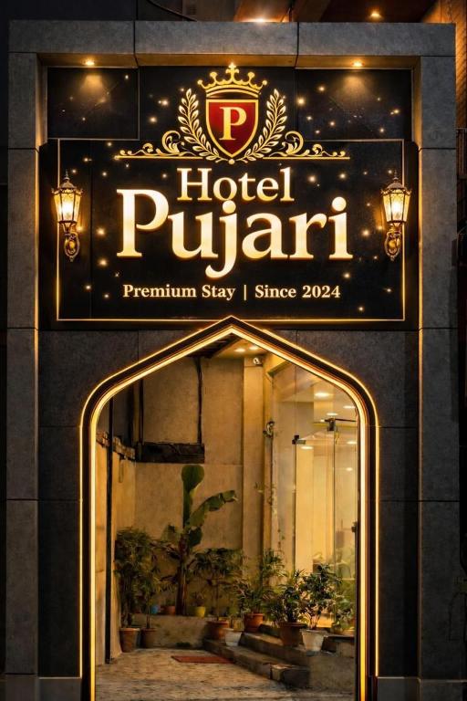 a sign for a hotel pupitt on the side of a building at Hotel Pujari in Khātu