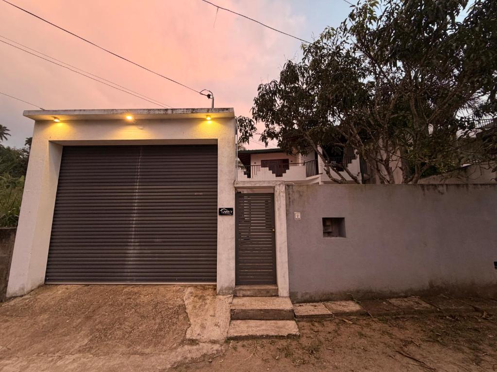 a garage with a garage door in front of a house at Rolling Hills Retreat in Katugastota