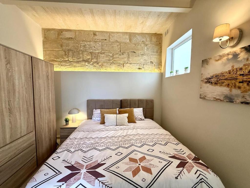 a bedroom with a large bed in a room at The Alley Suites in Gudja